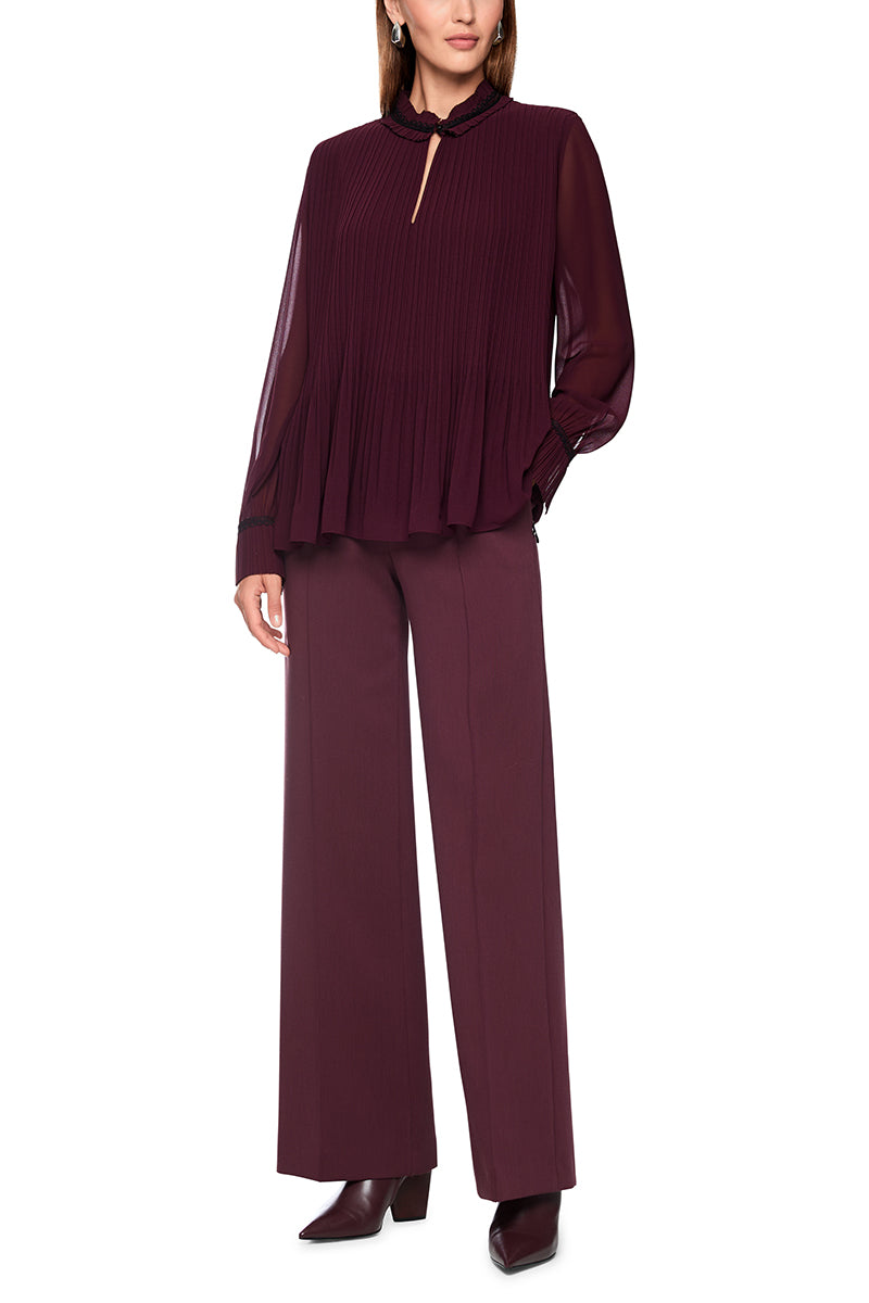 Pleated blouse with feminine details