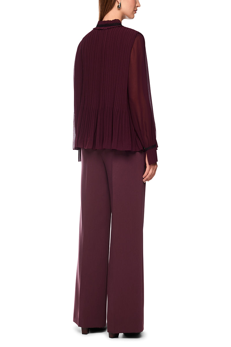 Pleated blouse with feminine details