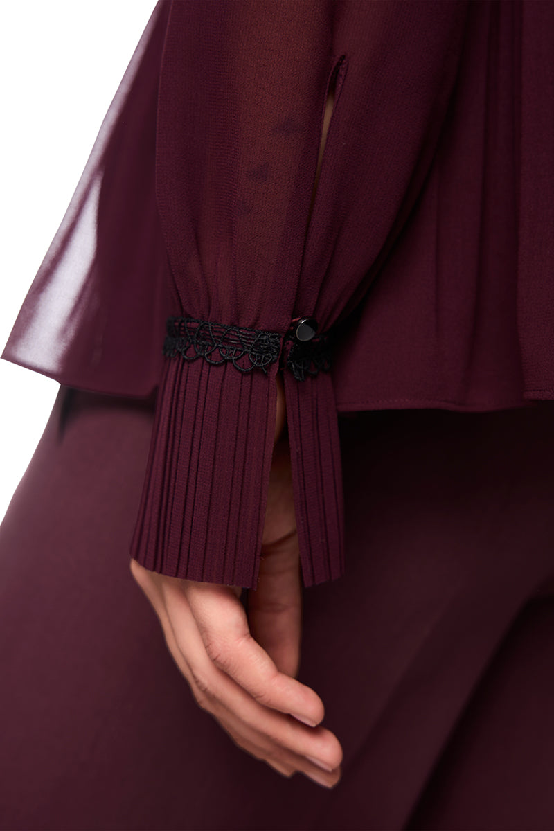 Pleated blouse with feminine details