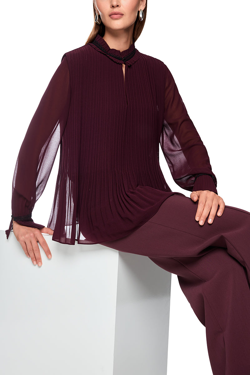 Pleated blouse with feminine details